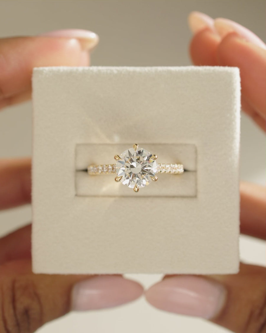 Round Cut Moissanite Six Claw Statement Engagement Ring with Pave Set Band - view 1