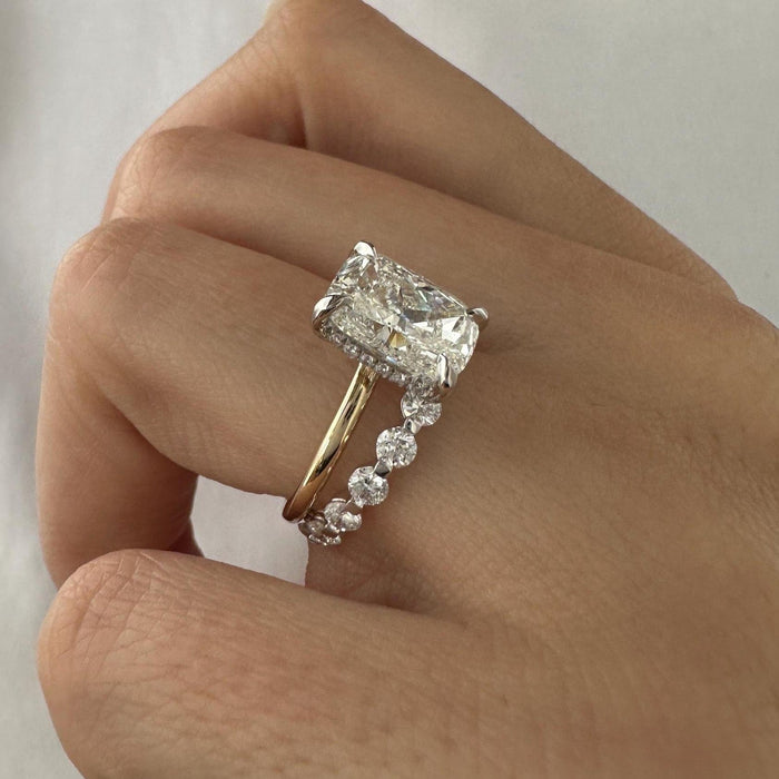 Angled view of elongated cushion moissanite ring showing the hidden halo and floating round stone band