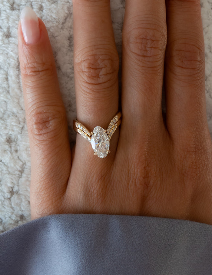 Close-up of elongated oval lab grown diamond V ring with pave shoulders and pave-tipped chevron band