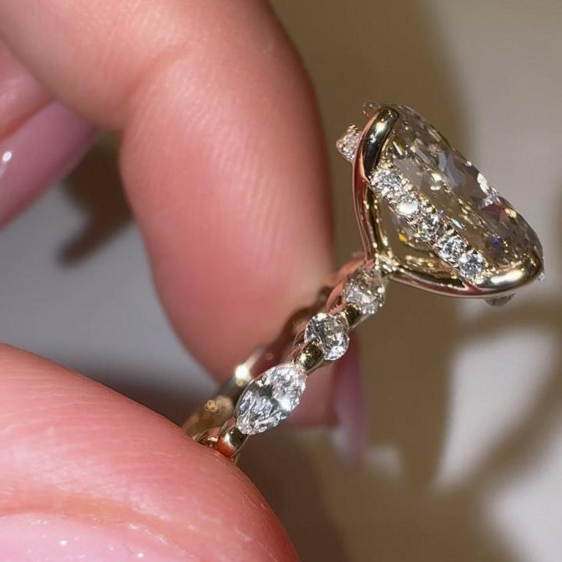 Oval cut moissanite engagement ring with marquise diamond accents in gold