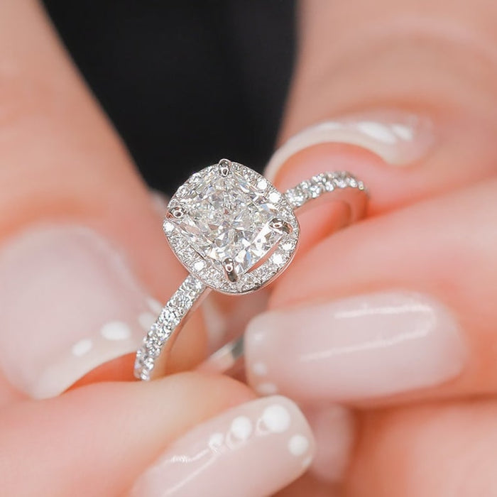 Cushion cut lab grown diamond halo ring on a pave band