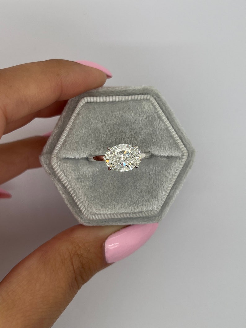 East west oval cut lab grown diamond solitaire ring in white metal