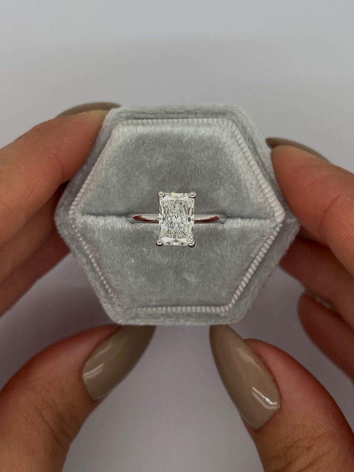 Radiant cut lab grown diamond solitaire ring in white metal on a thin plain band