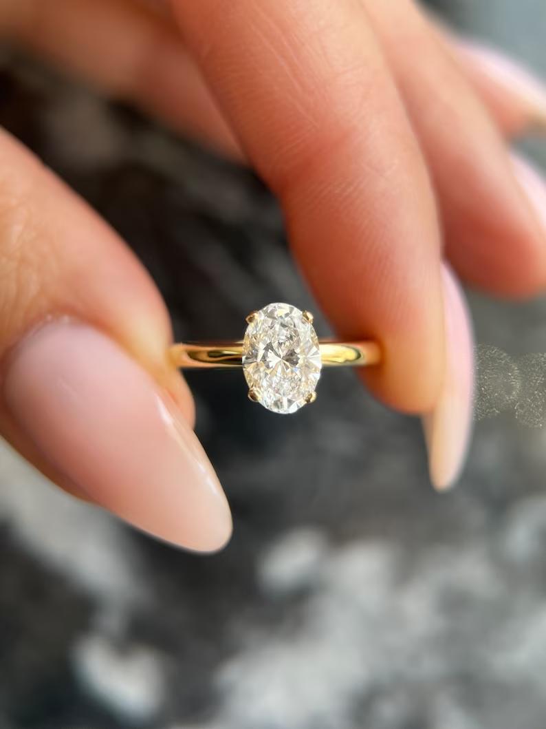 Oval cut lab grown diamond hidden halo solitaire ring in yellow gold