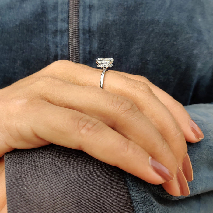 Hidden halo of small diamonds set into the collar beneath a cushion cut diamond