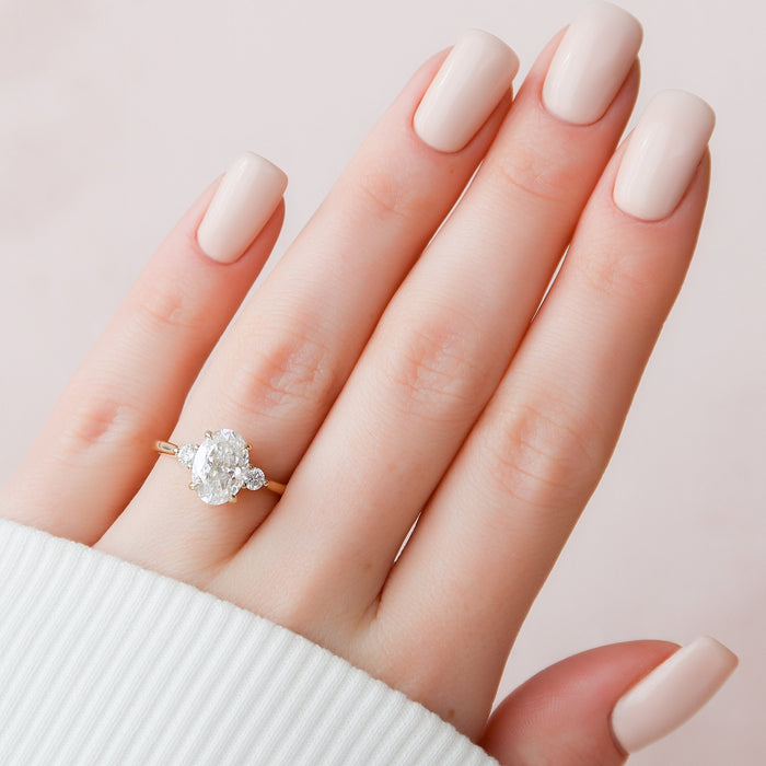 Oval moissanite three stone ring, front view
