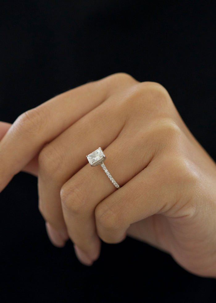 Radiant cut lab grown diamond solitaire engagement ring with a slim pave band in white gold