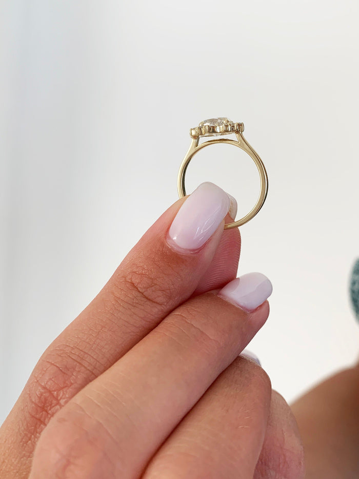 Oval cut lab grown diamond floral cluster engagement ring in yellow gold