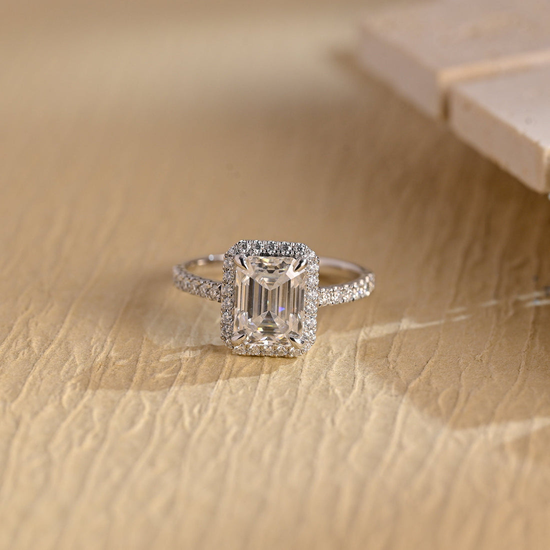 Emerald cut moissanite classic pave halo engagement ring with four claws and a slim pave set white gold band