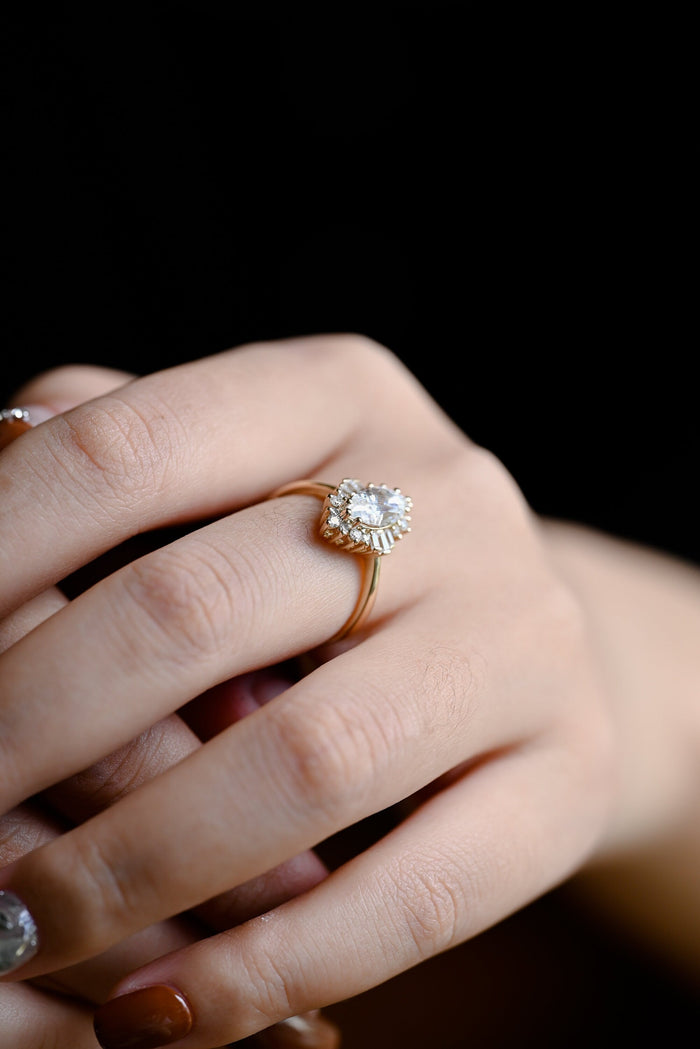 Art deco marquise cut moissanite halo engagement ring with baguette side clusters on a yellow gold band, view 2
