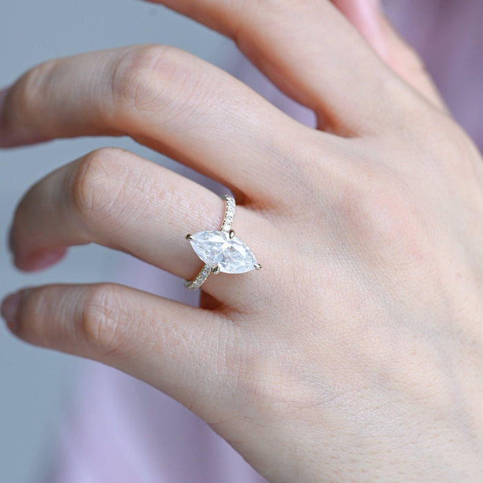 Four claw marquise cut moissanite solitaire engagement ring on a pave set yellow gold band, view 2