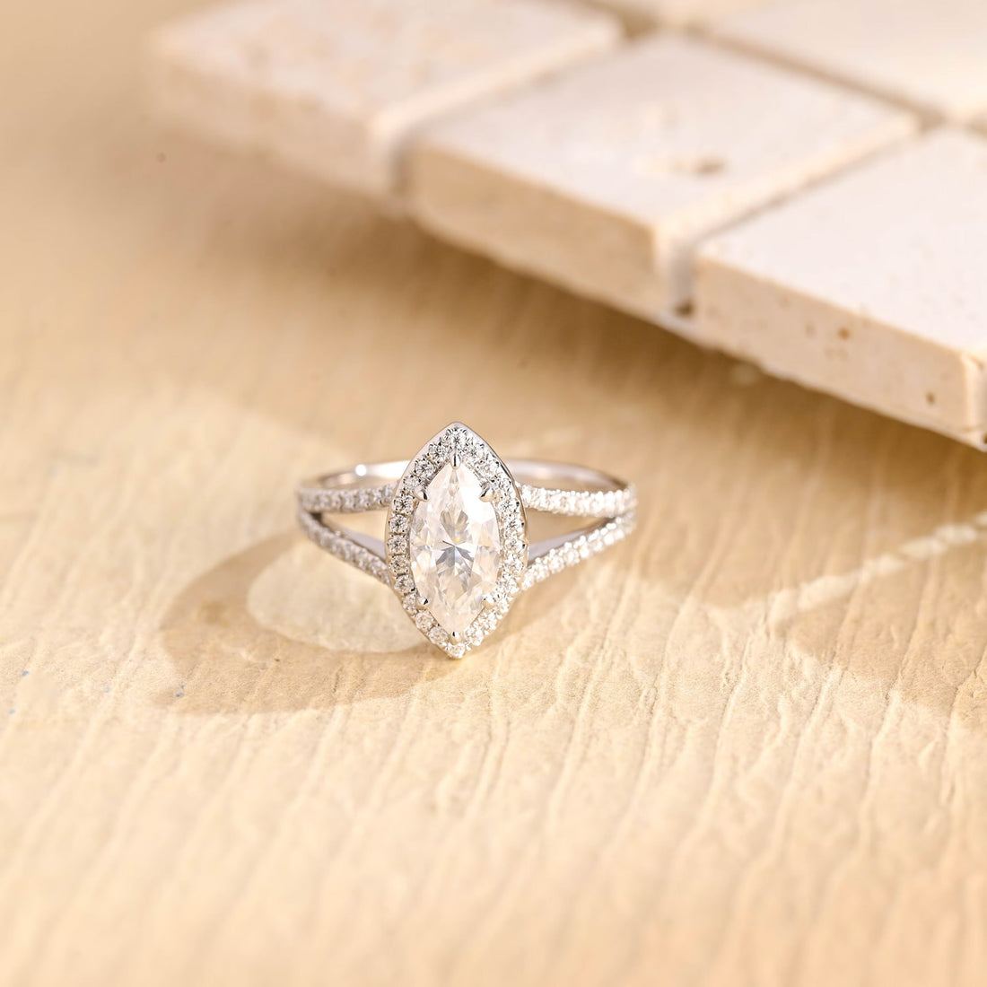 Marquise cut moissanite halo engagement ring with a pave set split shank band in white gold
