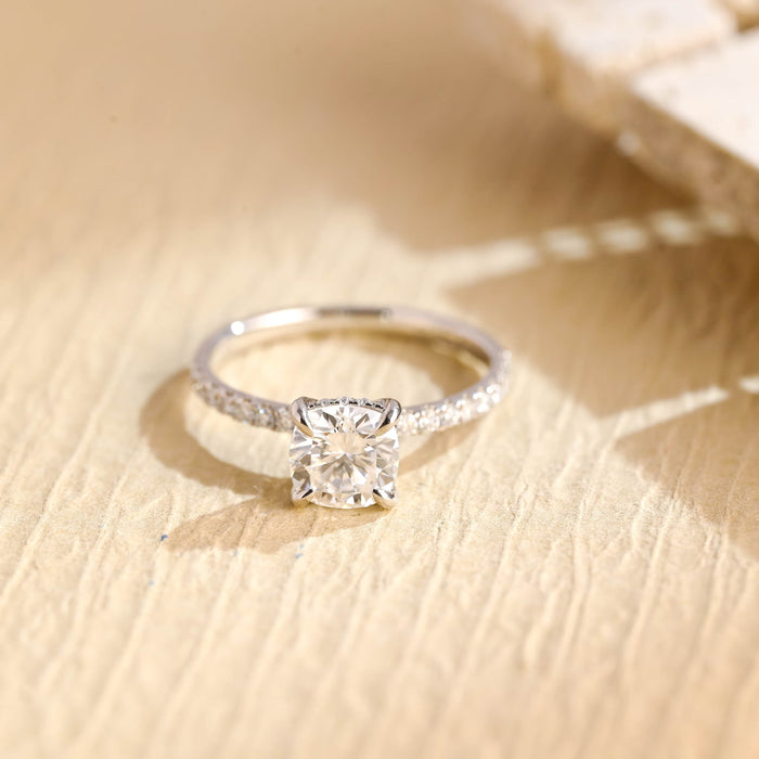 Square cushion moissanite hidden halo engagement ring in four claws on a slim white gold band micro pave set with tiny round stones