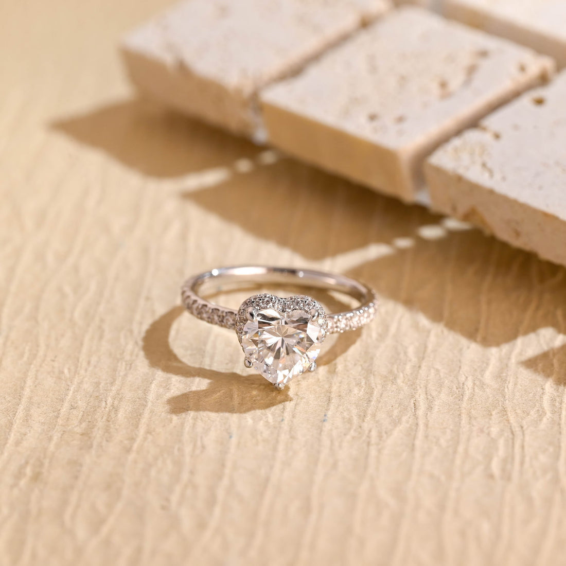 Heart cut moissanite hidden halo engagement ring with pave set white gold band