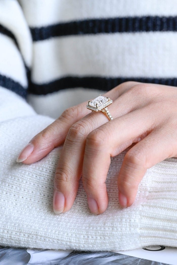 Radiant cut moissanite halo engagement ring in four claws with a pave set yellow gold band, view 2