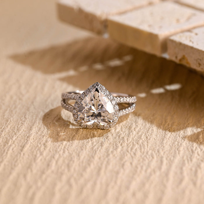 Heart cut moissanite halo engagement ring with a split shank pave set white gold band
