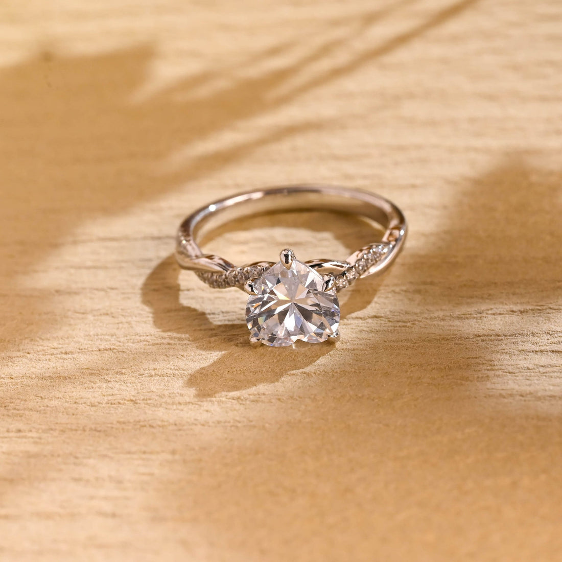 Heart cut moissanite solitaire engagement ring on a twisted pave set white gold band
