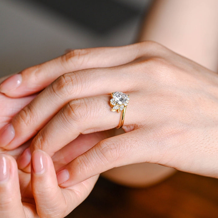 Heart cut moissanite cluster engagement ring with marquise leaf side stones on a yellow gold bypass band, view 2