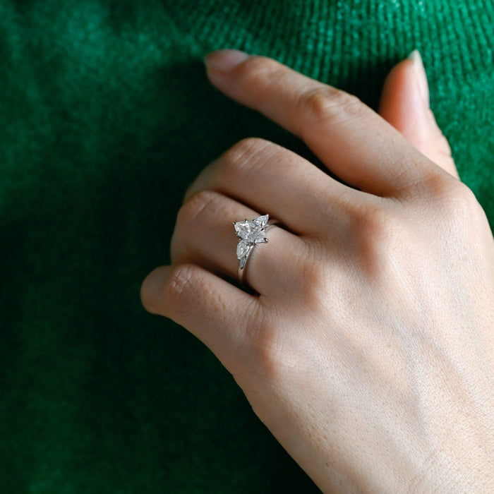 Marquise cut moissanite three stone engagement ring with pear side stones in a white gold setting on a yellow gold band, view 2