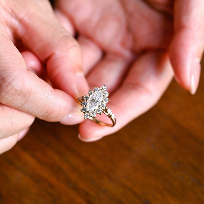 Marquise cut moissanite starburst floral halo engagement ring with spaced round and marquise shoulder stones on a yellow gold band, view 2