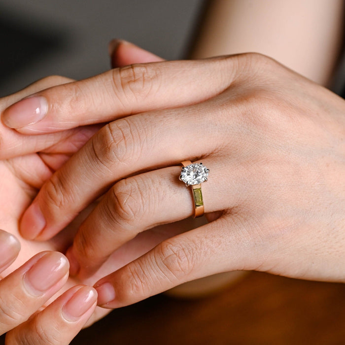Oval moissanite six claw solitaire engagement ring on a wide flat polished yellow gold band with white gold claws, view 2