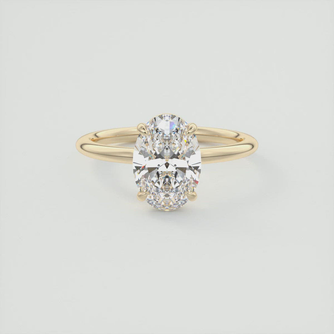 Oval cut moissanite low profile solitaire engagement ring in yellow gold