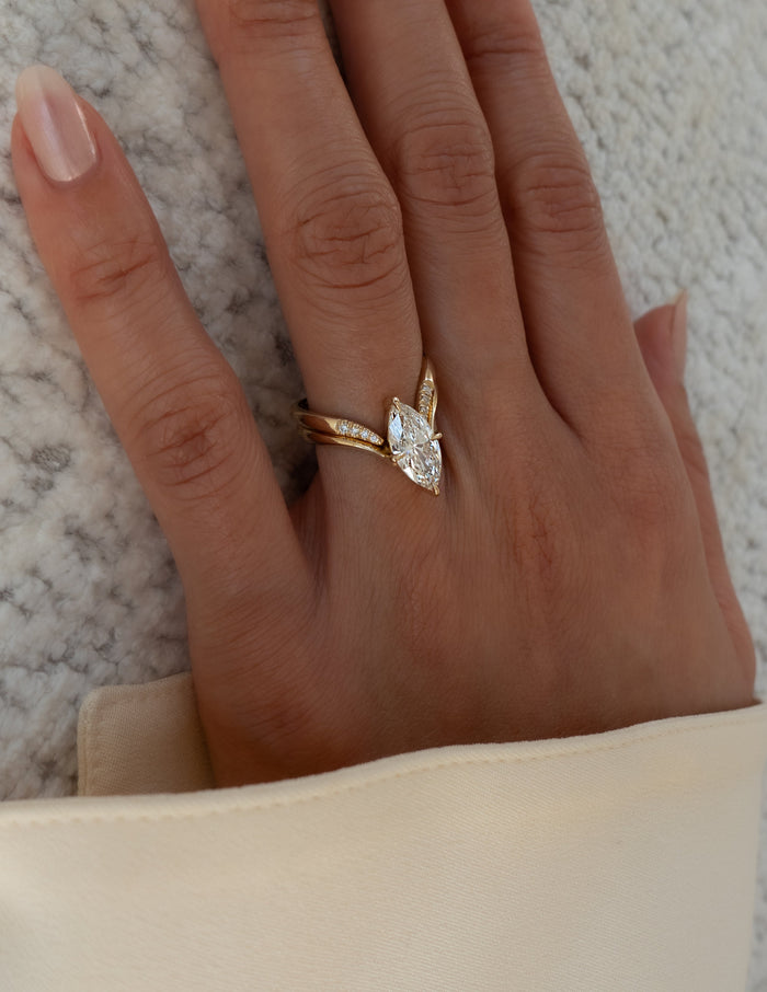 Side angle of marquise lab grown diamond V ring and pave-tipped chevron band worn on the hand