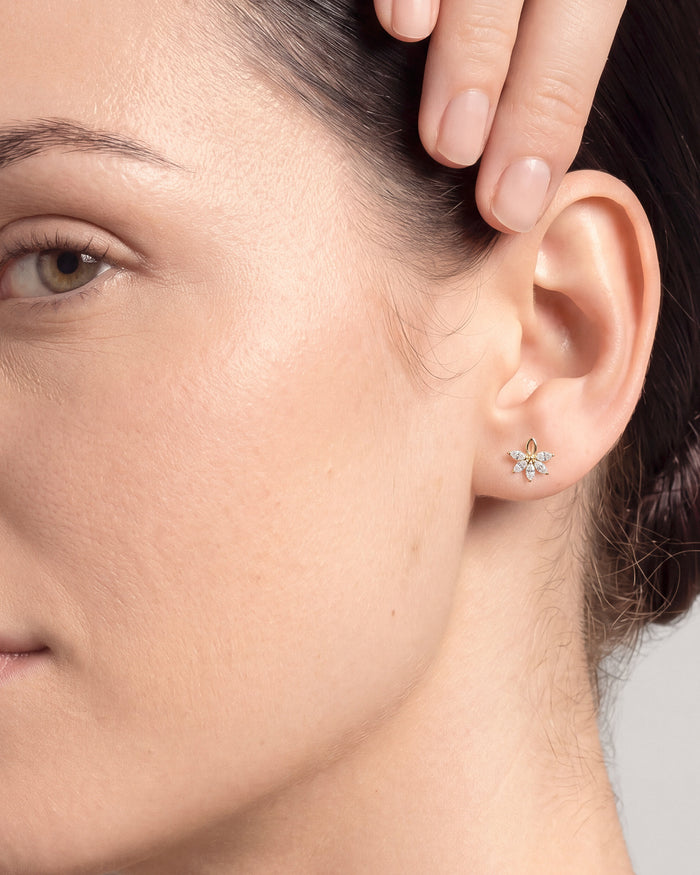 Model wearing marquise floral cluster lab grown diamond stud earrings, close up on the ear