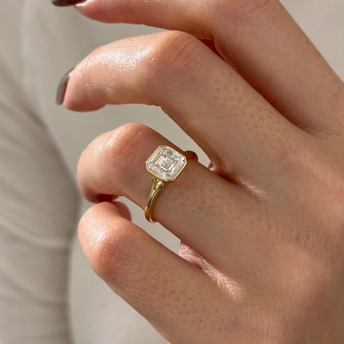 Asscher cut moissanite bezel split shank engagement ring in yellow gold, view 2