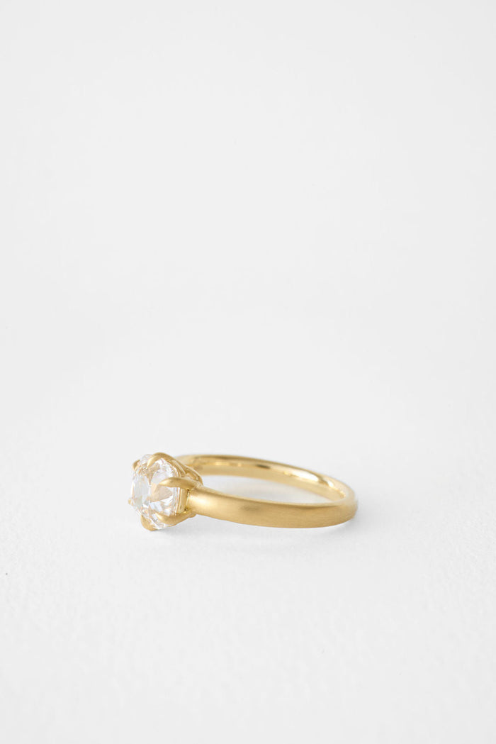 Antique cushion moissanite solitaire engagement ring on a brushed yellow gold band, view 2