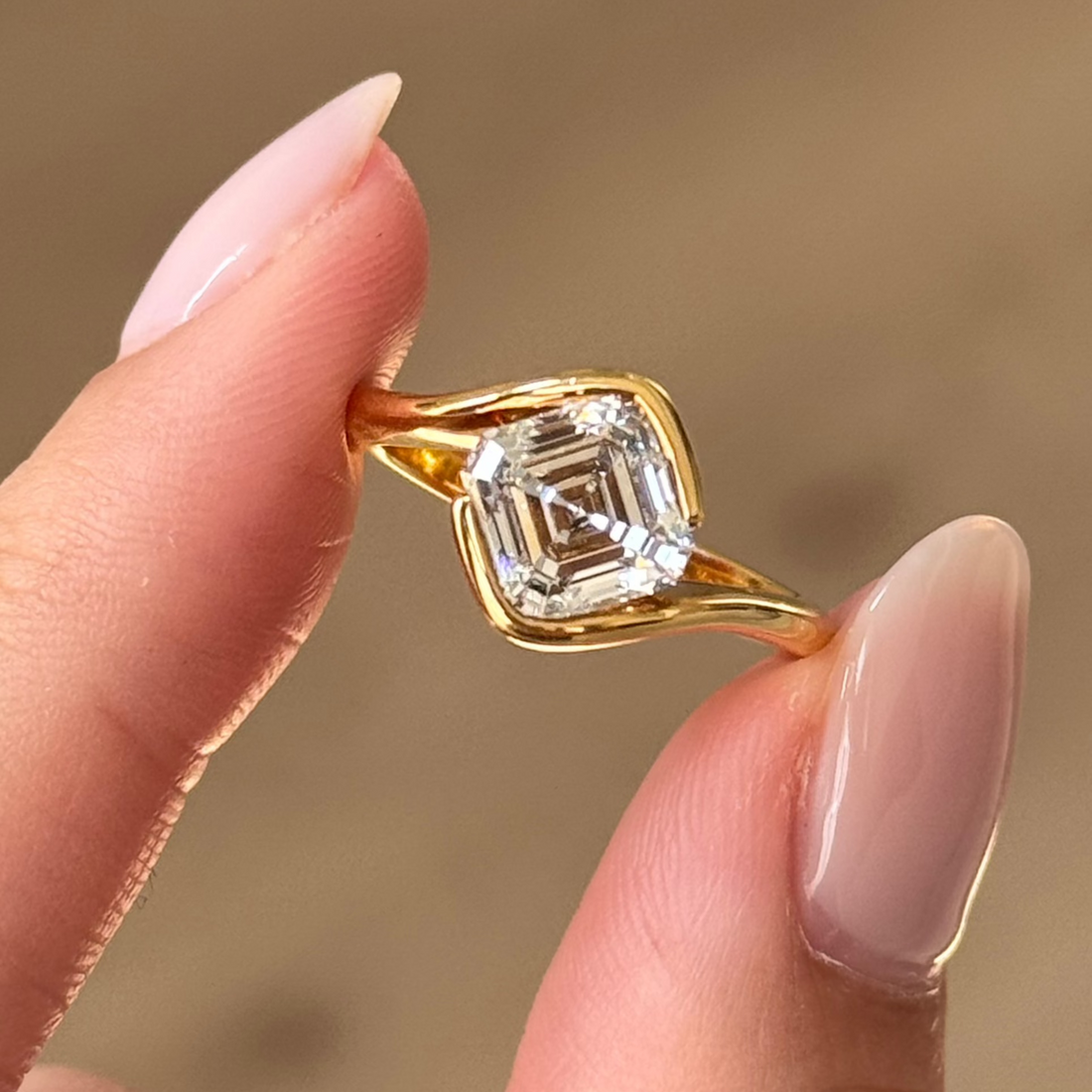 East west asscher cut moissanite swirl bypass solitaire engagement ring in yellow gold