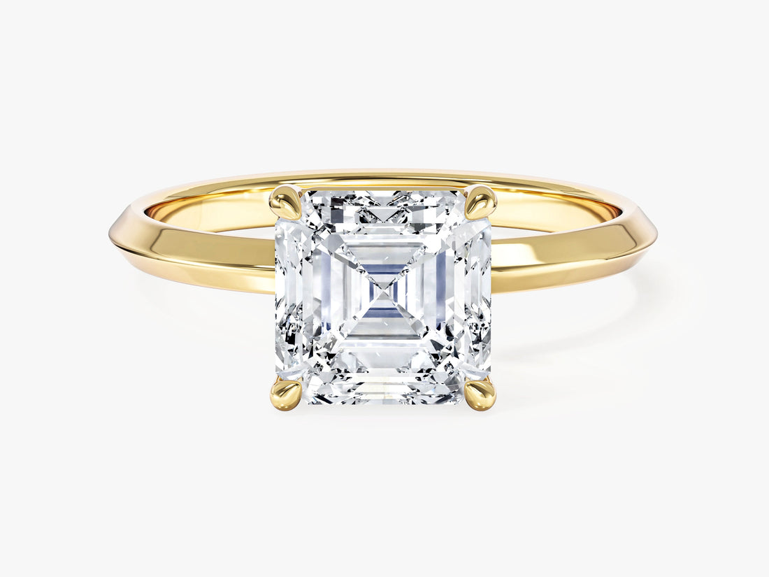 Square Asscher cut moissanite four claw engagement ring on a knife edge band in 14K yellow gold