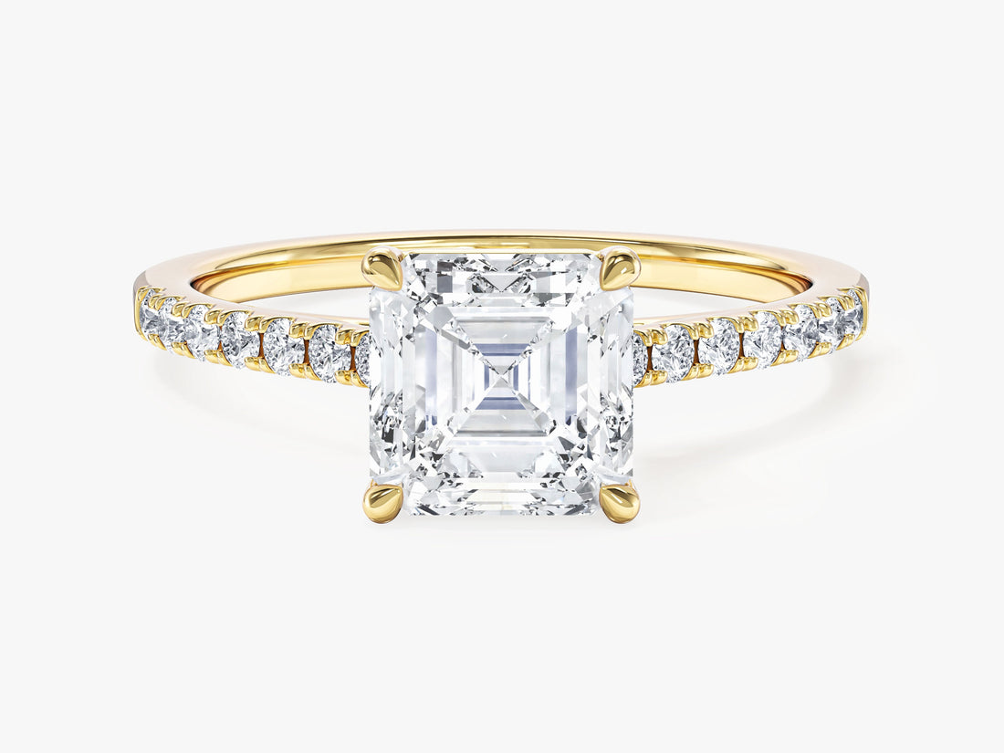 Asscher cut moissanite four claw solitaire engagement ring with pave band in 14K yellow gold, front view