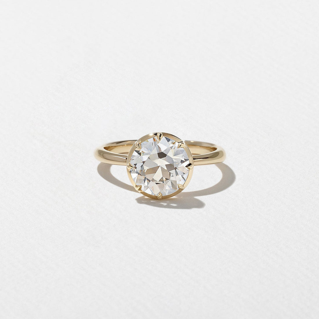Antique round cut moissanite solitaire engagement ring in yellow gold