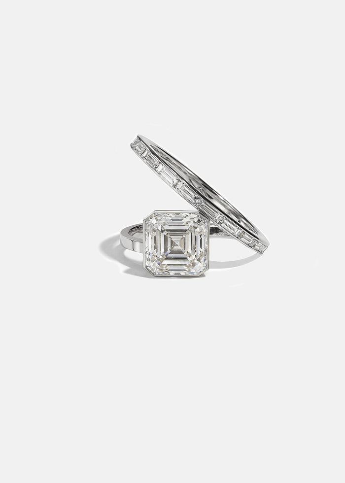 Asscher cut moissanite bezel set engagement ring on a spiral baguette band in yellow gold, view 2
