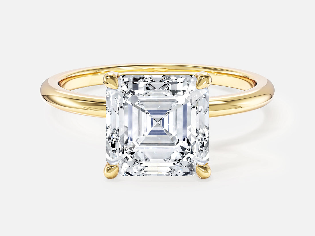 Asscher moissanite solitaire engagement ring on a slim round band in yellow gold, front view