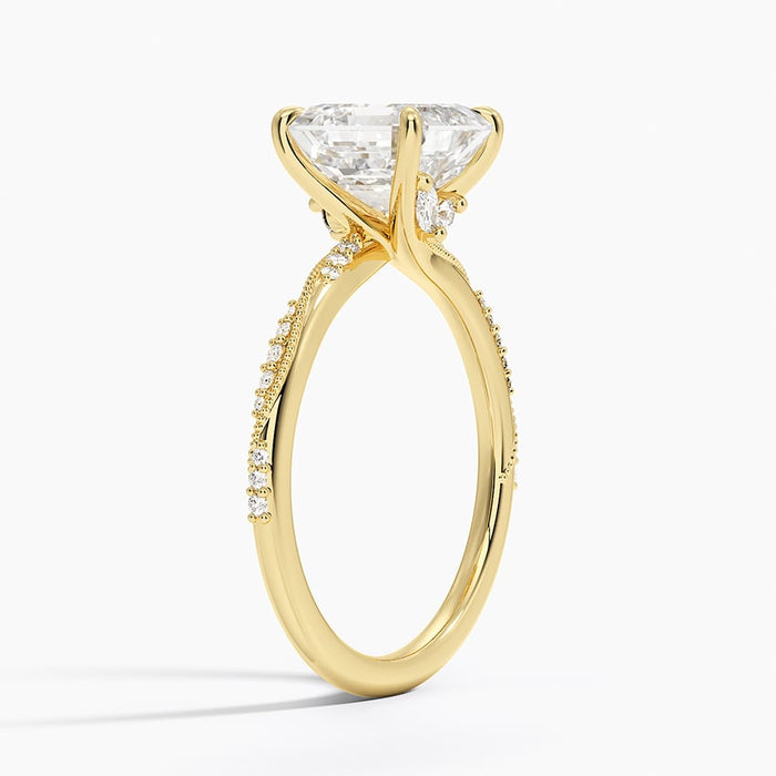 Side view showing milgrain bordered pave and a round accent beside the centre