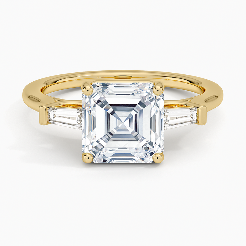 Asscher cut moissanite tapered baguette three stone ring in yellow gold, top view