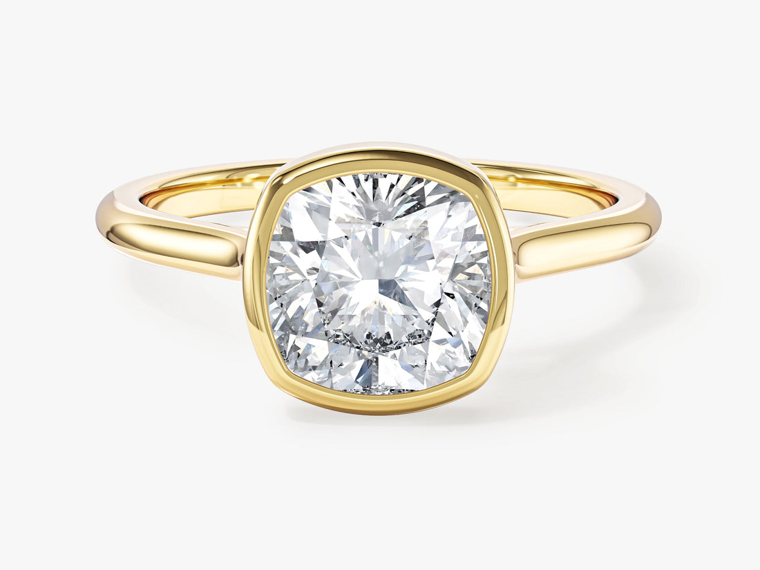 Cushion cut moissanite bezel solitaire engagement ring in yellow gold, front view