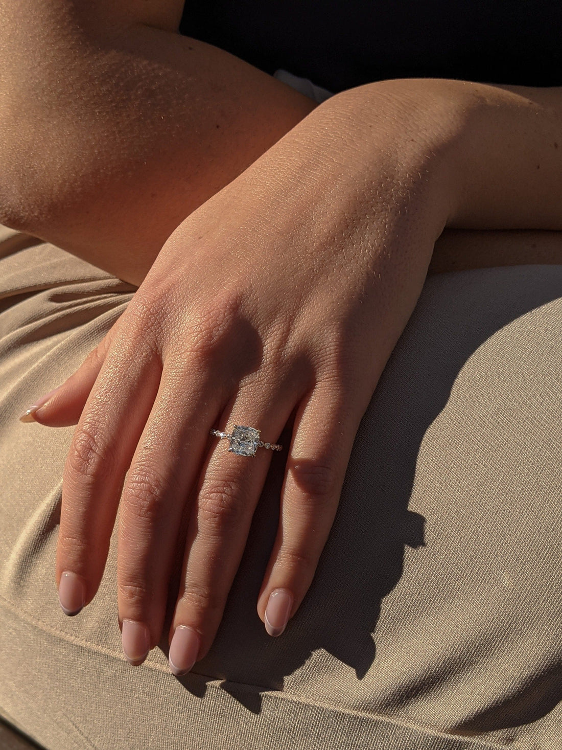 Cushion cut moissanite engagement ring with graduated accent shoulders in yellow gold, view 2