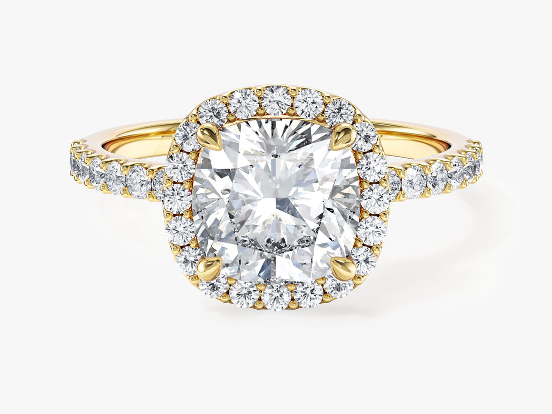 Cushion halo moissanite engagement ring with pave band in yellow gold, front view