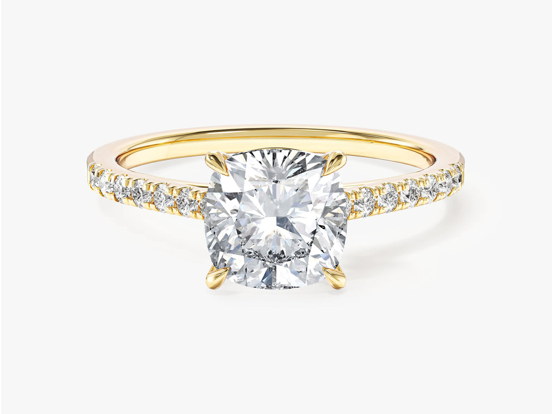 Four claw cushion moissanite solitaire engagement ring with micro pave shoulders in yellow gold
