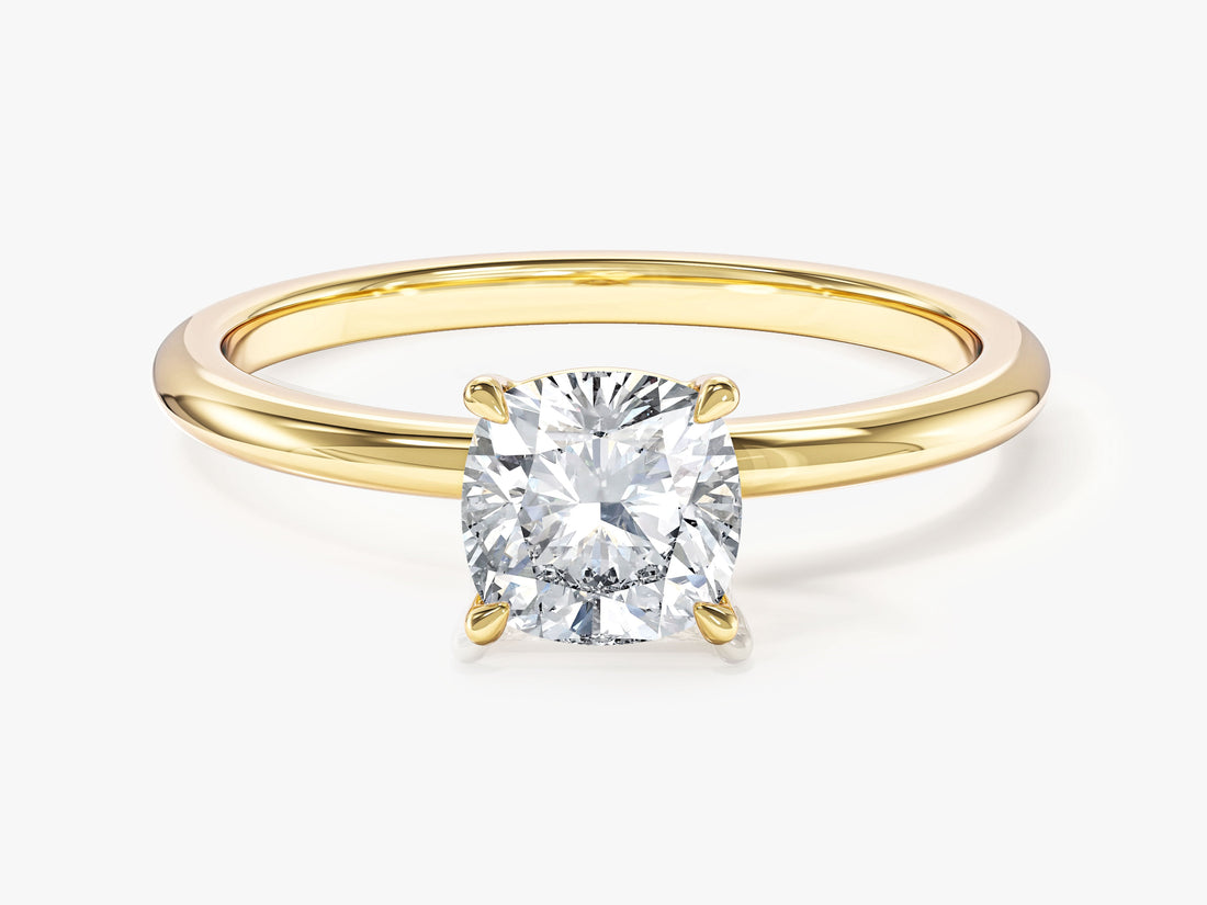 Cushion cut lab grown diamond solitaire on a thin yellow gold band, front view