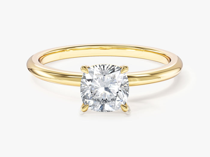 Cushion cut lab grown diamond solitaire on a thin yellow gold band, front view