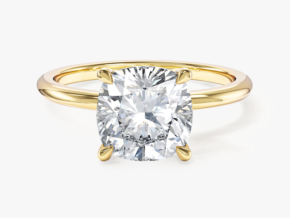 Large cushion cut lab grown diamond solitaire with teardrop prongs in yellow gold, front view