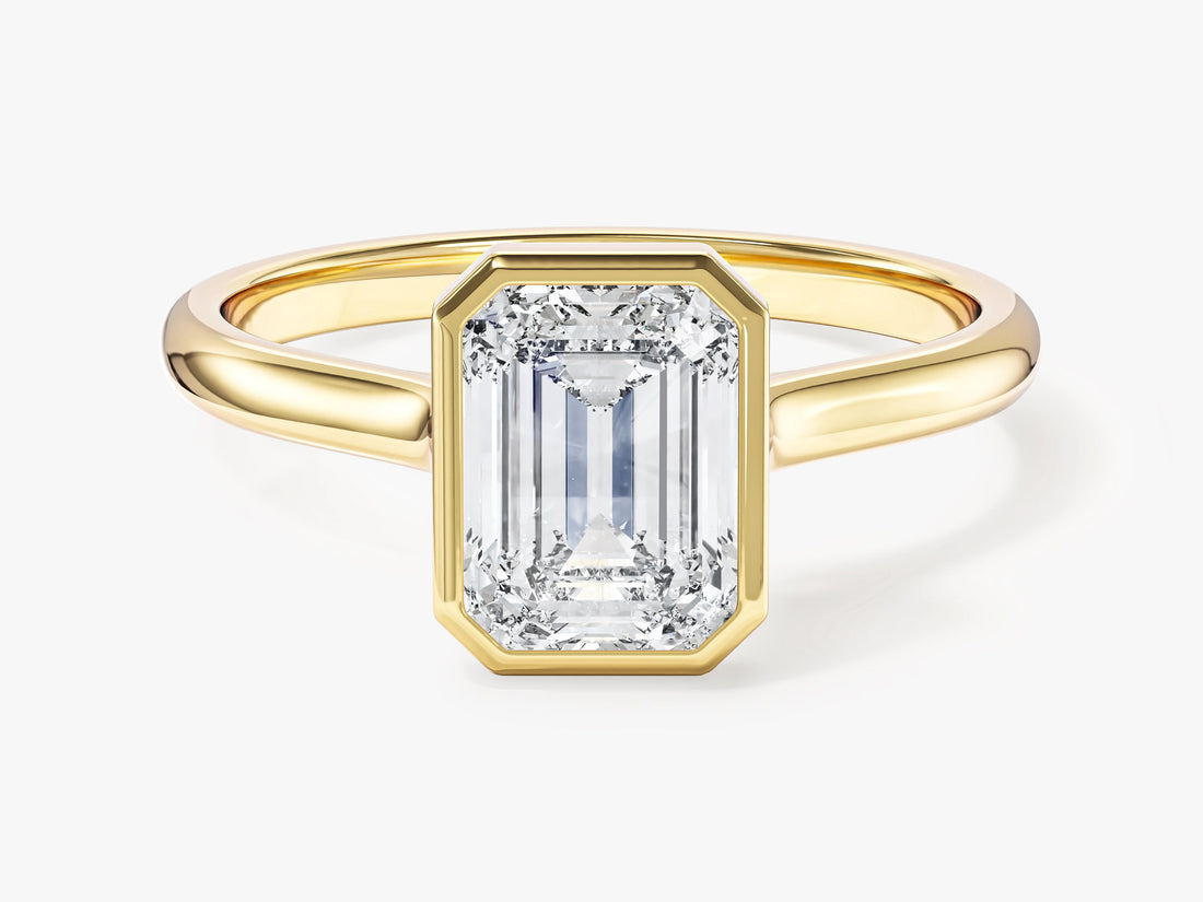 Bezel set emerald moissanite minimalist solitaire engagement ring in 14K yellow gold, front view