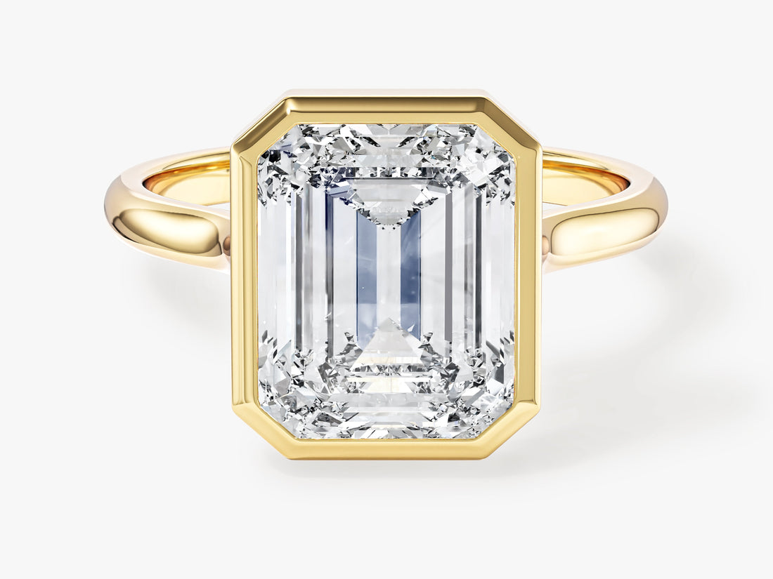 Large emerald cut moissanite statement engagement ring, bezel set solitaire in 14K yellow gold, front view
