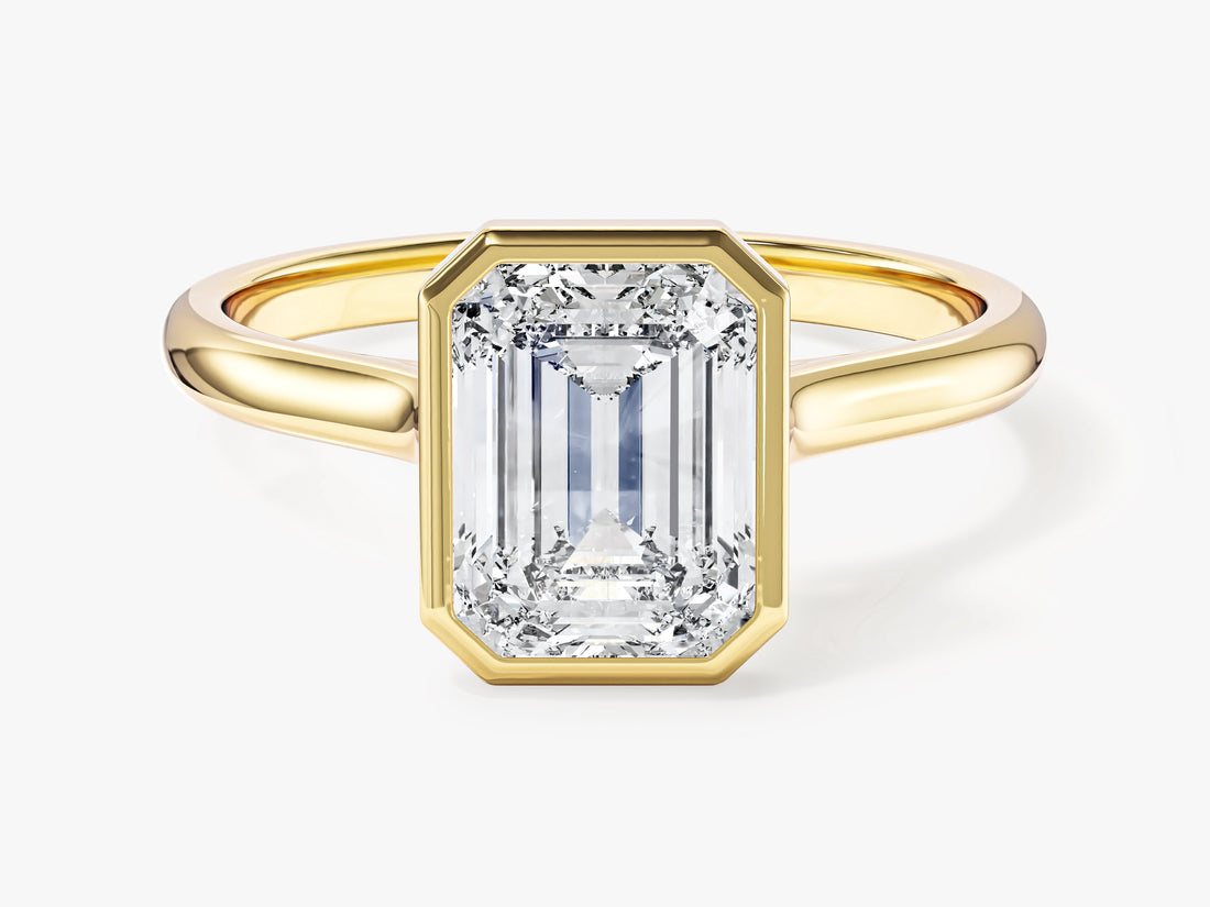 Emerald cut lab grown diamond bezel solitaire engagement ring in yellow gold, front view