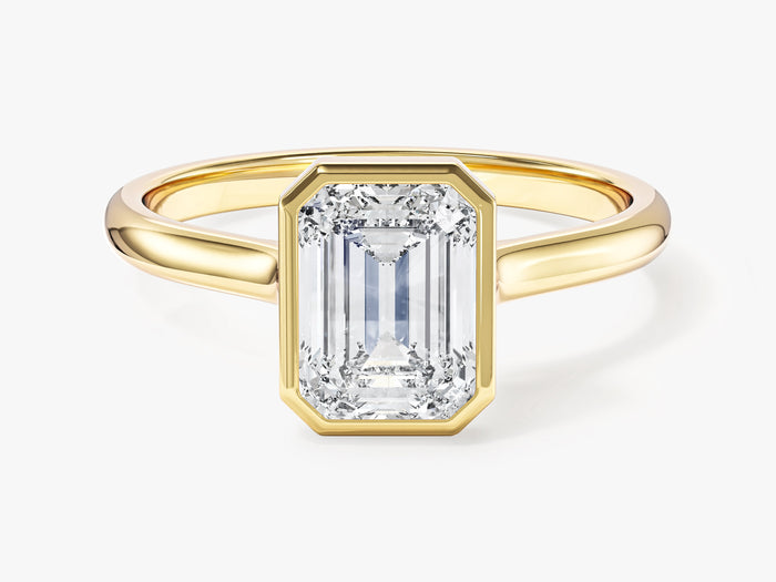 Bezel set emerald cut lab grown diamond minimalist engagement ring in yellow gold, front view