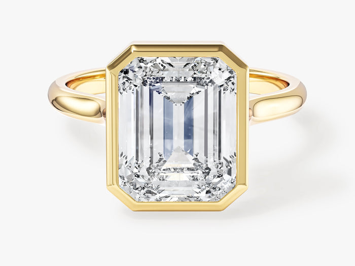 Large emerald cut lab grown diamond rub over bezel engagement ring in yellow gold, front view